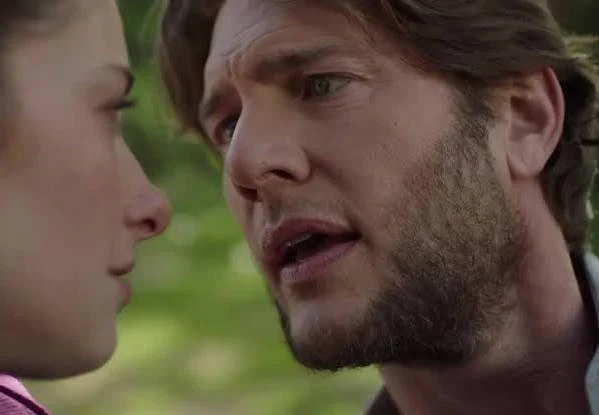 Close-up of Ryan McPartlin speaking with a woman outdoors