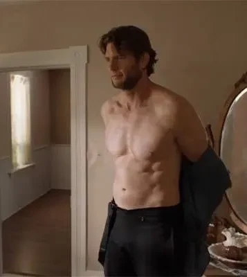 Ryan McPartlin putting on a dark jacket in an interior scene